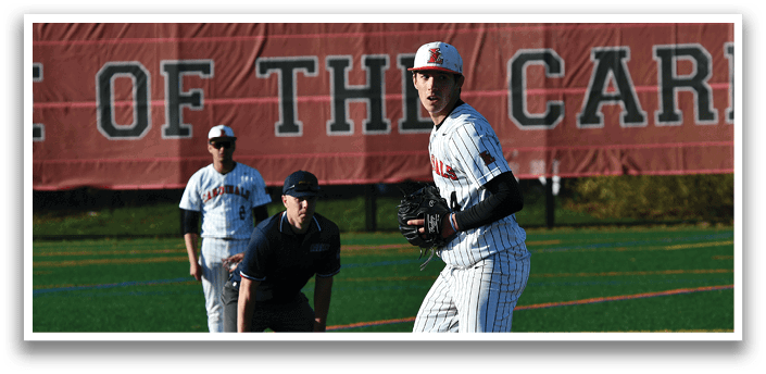 A baseball player in a white and black uniform is standing on the pitcher's mound. Description generated by AI