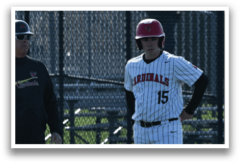 A baseball game is taking place with three men standing on the field. Description generated by AI