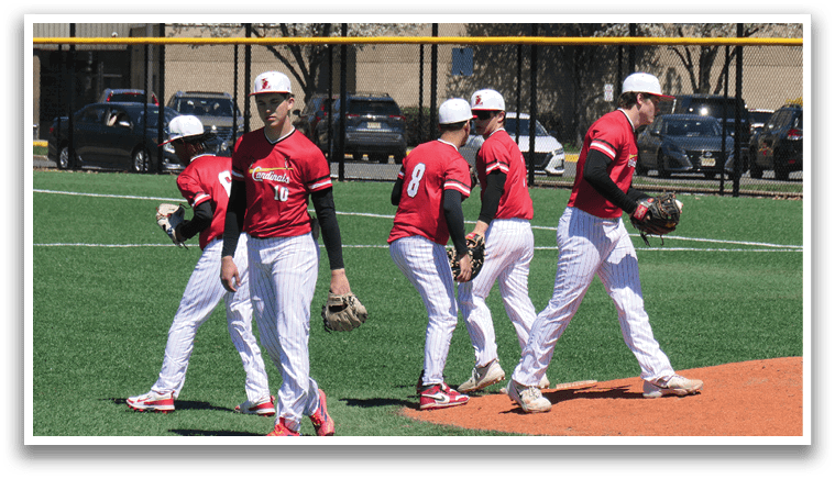 A group of baseball players walking on a field. Description generated by AI