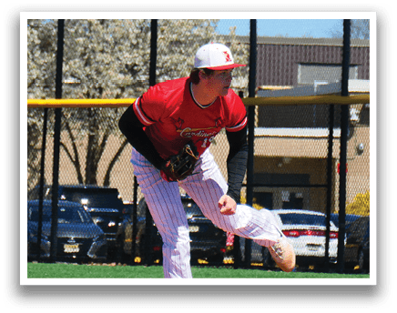 A baseball player in a red shirt and white pants is pitching a ball. Description generated by AI