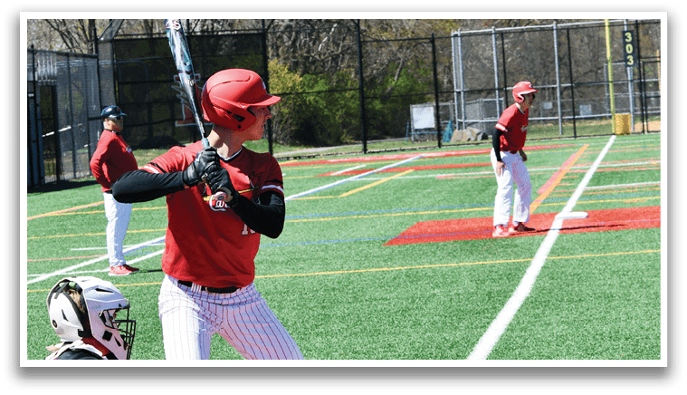 A baseball player in a red helmet and white uniform is holding a bat and getting ready to swing. Description generated by AI