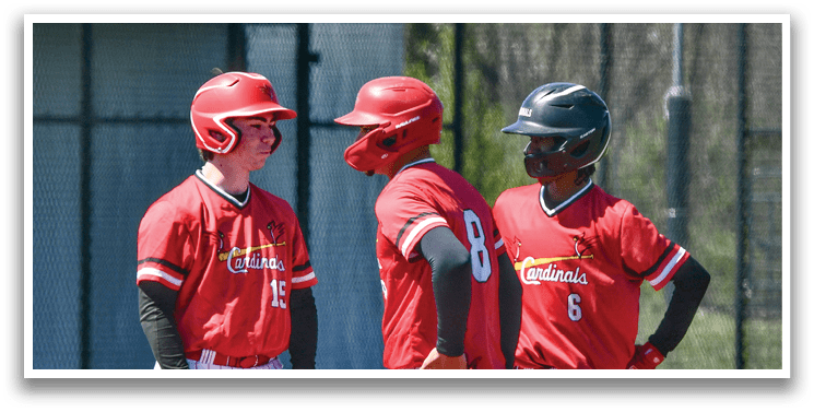 Three baseball players wearing red shirts and white pants. Description generated by AI