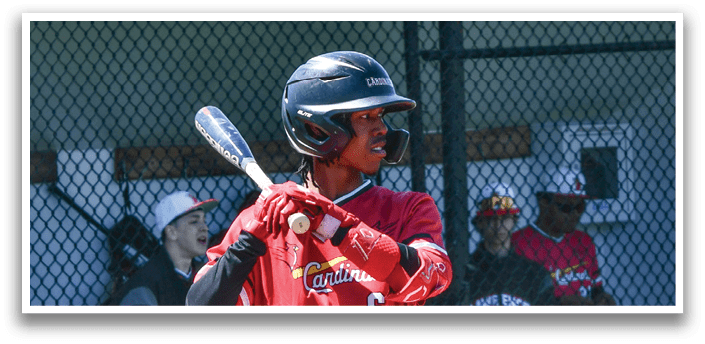 A baseball player in a red and white uniform holding a bat. Description generated by AI