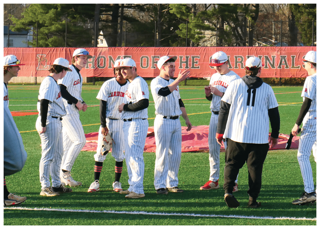 A group of baseball players wearing white and black uniforms. Description generated by AI