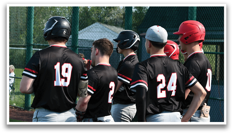A group of baseball players wearing black shirts and red hats. Description generated by AI