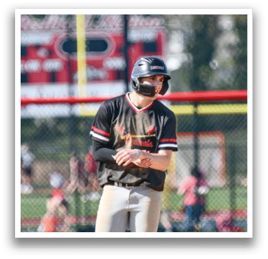 A baseball player wearing a black helmet and a black and red jersey. Description generated by AI