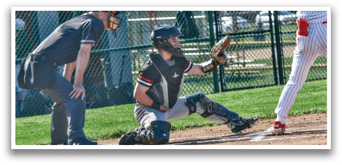 A baseball player is at bat, ready to swing. Description generated by AI