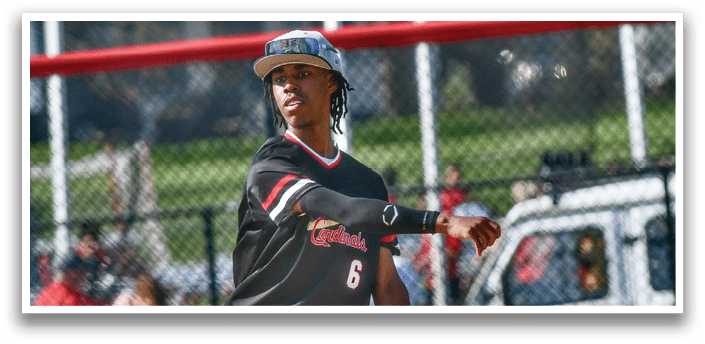 A baseball player wearing a black shirt and grey pants. Description generated by AI