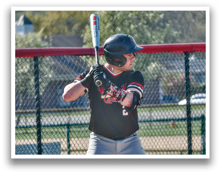 A baseball player in a black helmet and grey uniform is holding a bat and getting ready to swing. Description generated by AI
