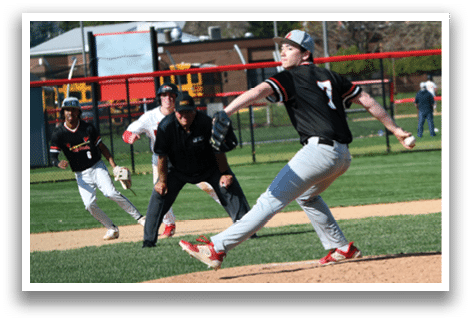 A baseball player in a black shirt and red shoes is pitching a ball. Description generated by AI