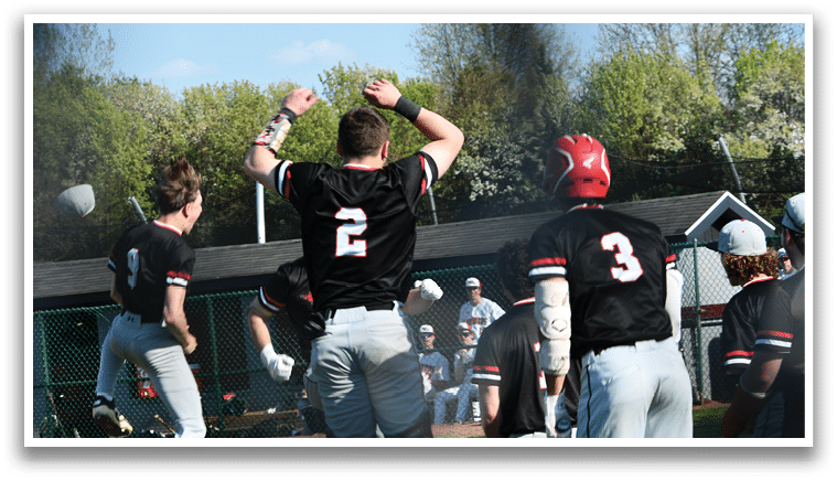 A group of baseball players celebrating a win. Description generated by AI