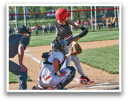 A baseball player is swinging a bat at a ball. Description generated by AI