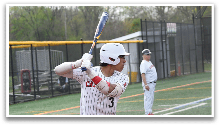 A baseball player is swinging a bat on a field. Description generated by AI