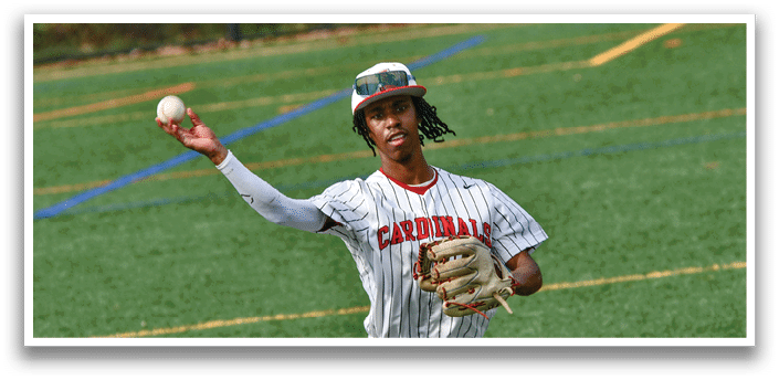 A baseball player in a white uniform is holding a baseball. Description generated by AI