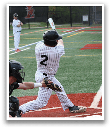 A baseball player in a black helmet and white uniform is swinging a bat. Description generated by AI