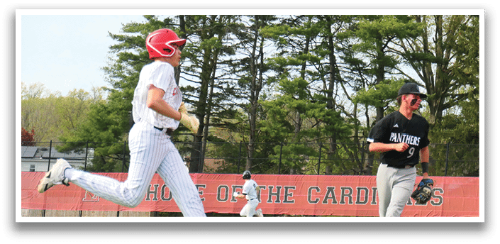 A baseball player running towards a base. Description generated by AI