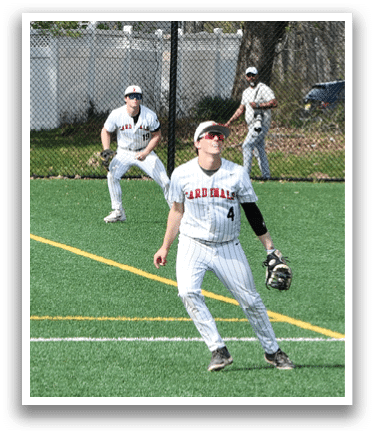A baseball player wearing a white uniform and a black hat. Description generated by AI