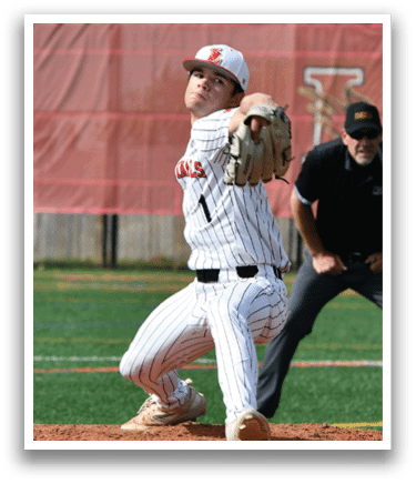 A baseball player in a black and white uniform is pitching a ball. Description generated by AI