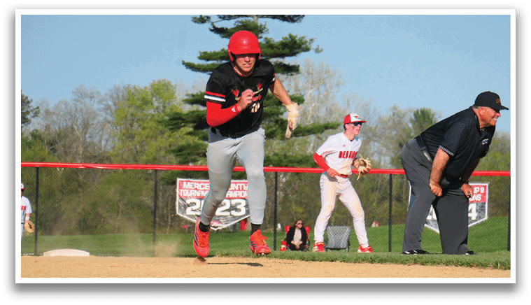 A baseball player running to a base. Description generated by AI