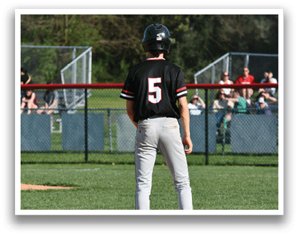 A baseball player wearing a black shirt with the number 5 on it. Description generated by AI