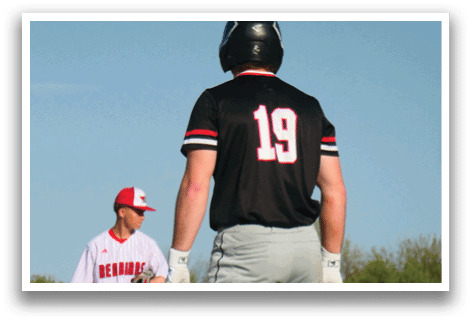 A baseball player wearing a black shirt with the number 19 on it. Description generated by AI