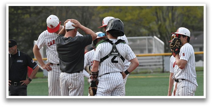 A group of baseball players wearing red and white uniforms. Description generated by AI