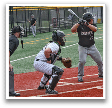 A baseball player is holding a bat and getting ready to hit the ball. Description generated by AI