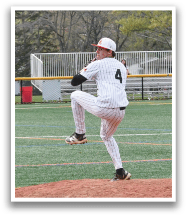 A baseball player in a white and black uniform is pitching a ball. Description generated by AI