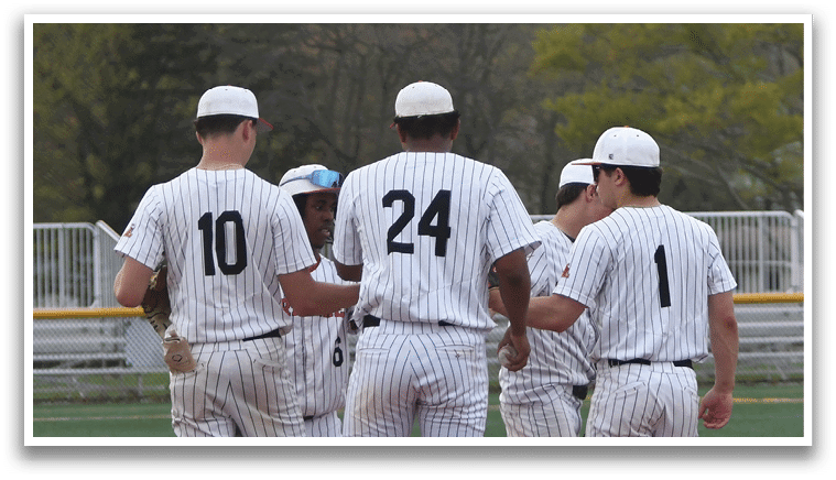 A group of baseball players standing on a field. Description generated by AI