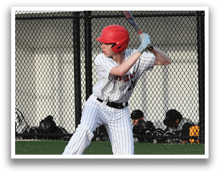 A baseball player in a red helmet and white uniform is swinging a bat. Description generated by AI