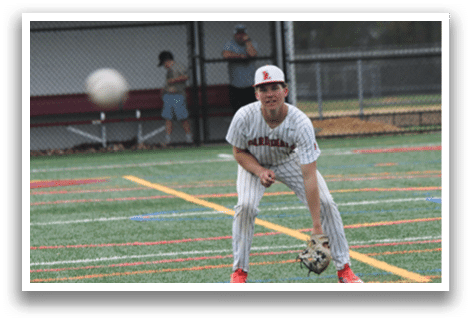 A baseball player in a white and red striped uniform is playing catch. Description generated by AI