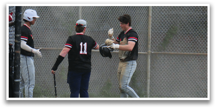 A baseball player wearing a black shirt with the number 11 on it. Description generated by AI