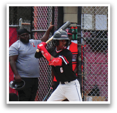 A baseball player is at bat, holding a bat and preparing to swing. Description generated by AI