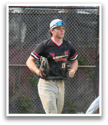 A baseball player wearing a black and red shirt and white pants. Description generated by AI