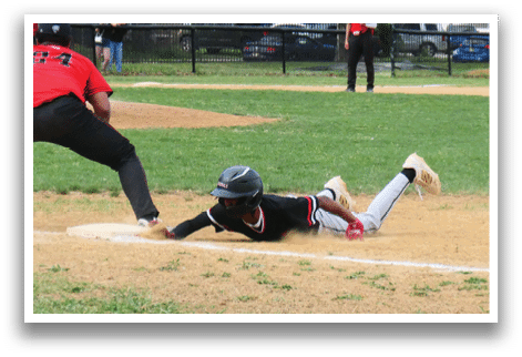 A baseball player slides into a base. Description generated by AI