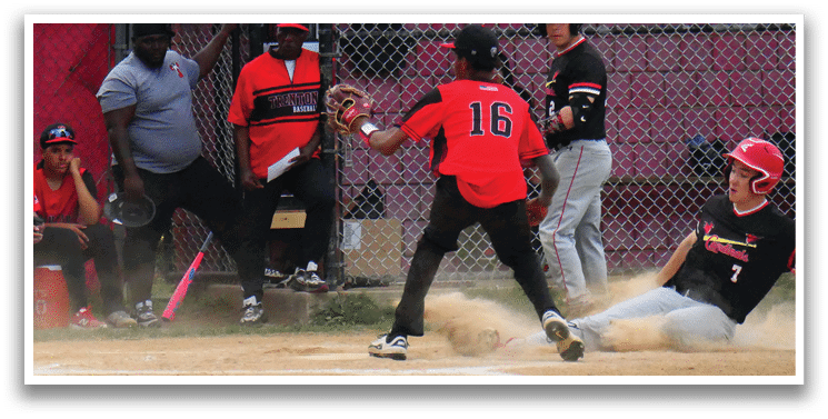 A baseball player sliding into home plate. Description generated by AI