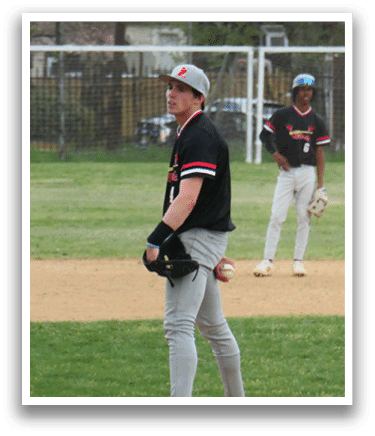 A baseball player standing on a mound. Description generated by AI
