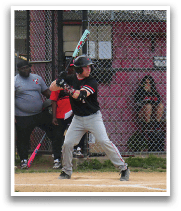 A baseball player is holding a bat and getting ready to hit the ball. Description generated by AI
