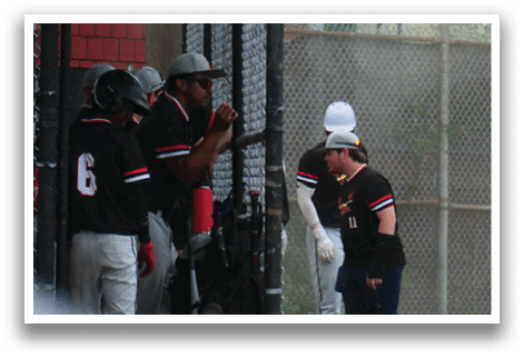 A baseball player is holding a bat. Description generated by AI