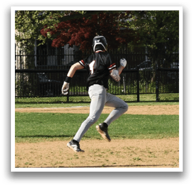 A baseball player running to first base. Description generated by AI