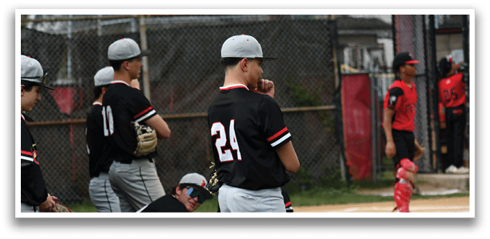 A baseball player wearing a black shirt with the number 24 on it. Description generated by AI