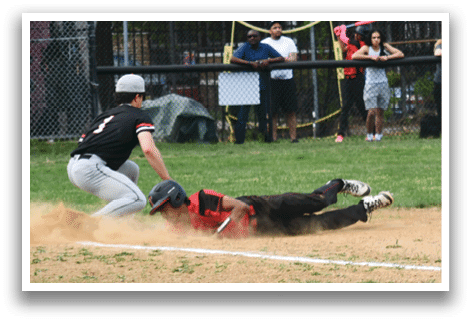 A baseball game is taking place with a player sliding into home base. Description generated by AI