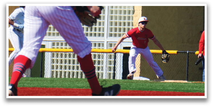 A baseball player wearing a red shirt and white pants is running towards a base. Description generated by AI