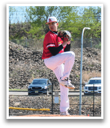 A baseball player in a red and white uniform is on the pitcher's mound. Description generated by AI