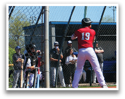 A baseball player in a red shirt and white pants holding a bat. Description generated by AI
