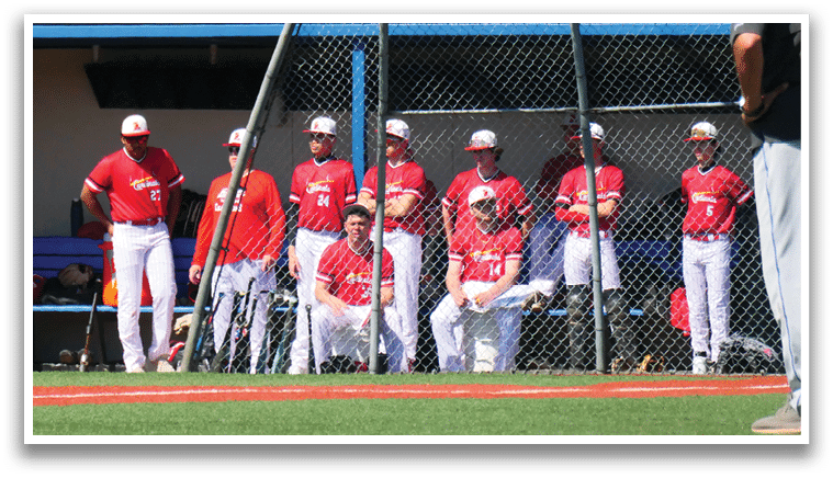 A baseball field with a group of players and a coach. Description generated by AI
