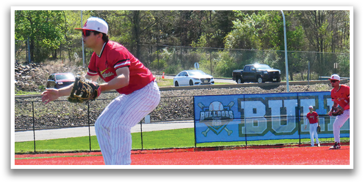 A baseball player in a red shirt and white pants is catching a ball. Description generated by AI