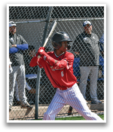 A baseball player is swinging a bat on a field. Description generated by AI