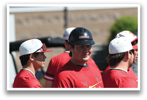 A group of baseball players wearing red shirts and red hats. Description generated by AI