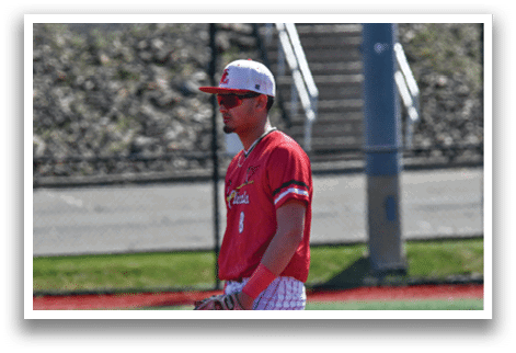 A baseball player wearing a red and white striped shirt and a red hat. Description generated by AI